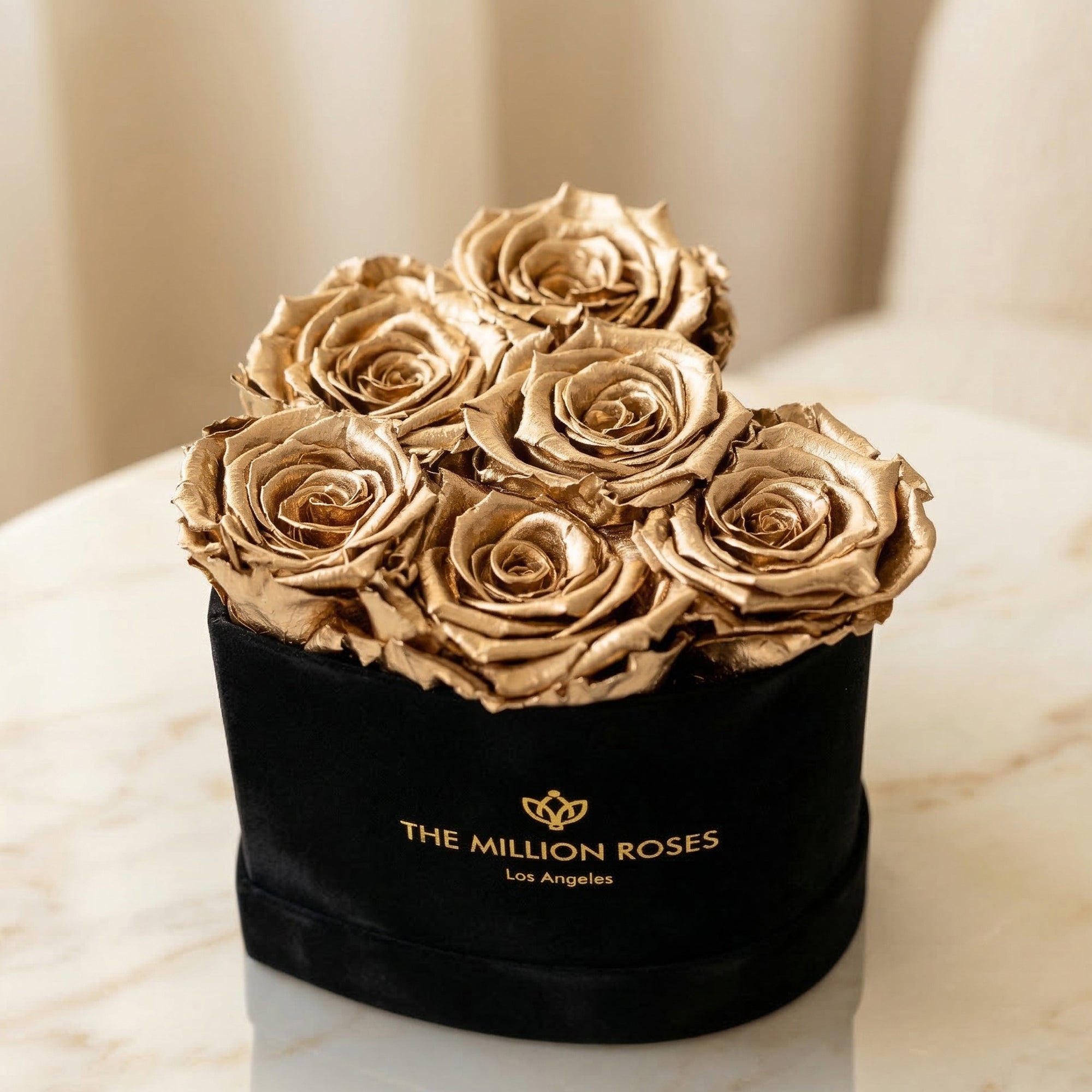 Close-up of gold roses in black box with gold logo, luxurious dried flower decor for home or gift, SKU: 01112000149021
