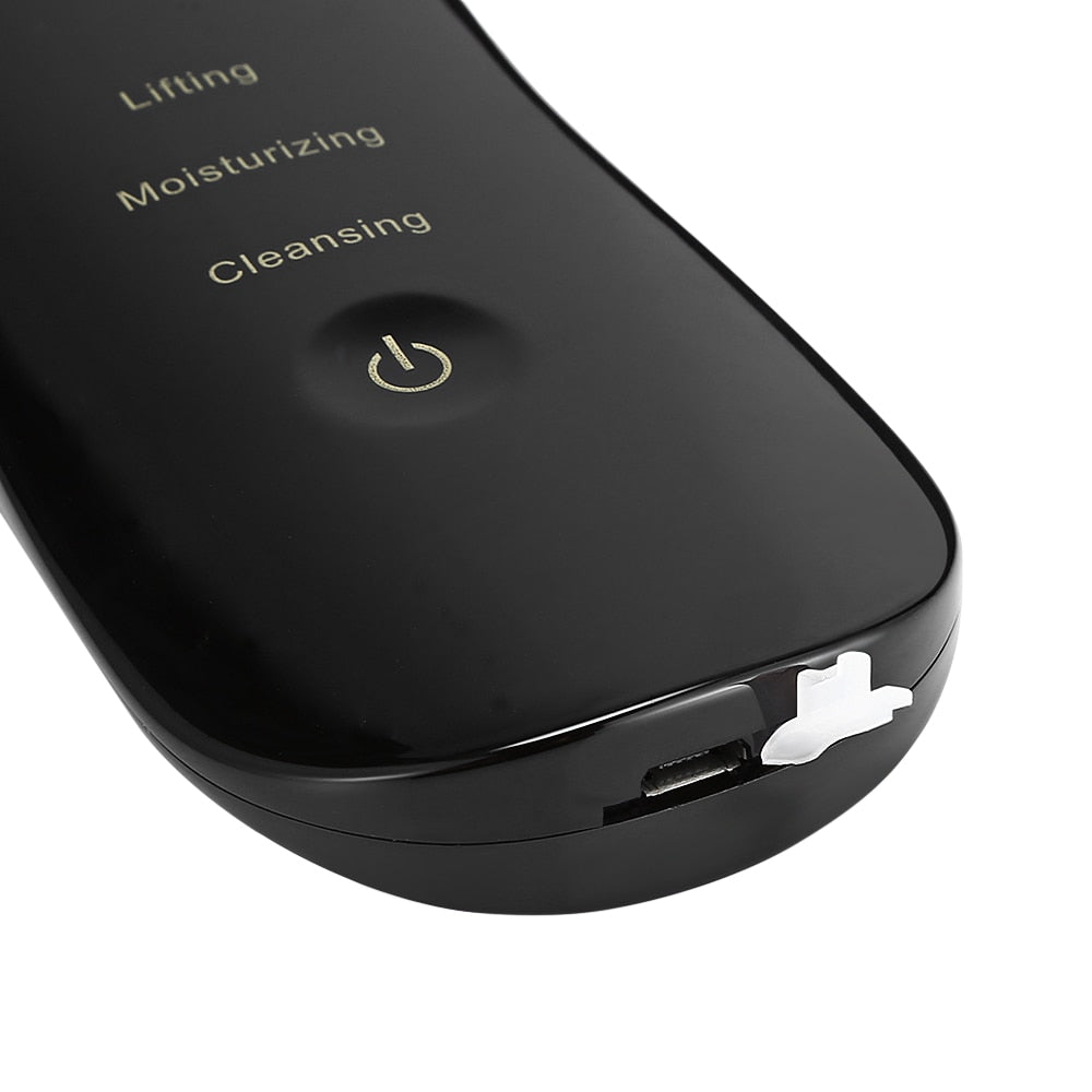 Close-up of black ultrasonic skin scrubber with power button and function labels for lifting, moisturizing, and cleaning, detailed view